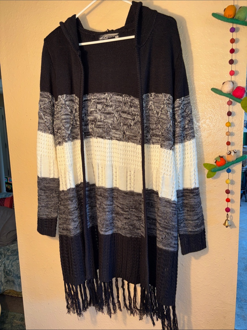NWOT Almost Famous brand cardigan featuring a black, grey, and white strip